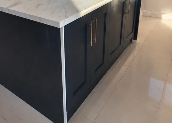 Navy shaker kitchen island with white marble-effect worktop